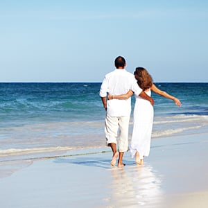 Couples are walking together on a beach. Calcium orotate provides overall wellness.