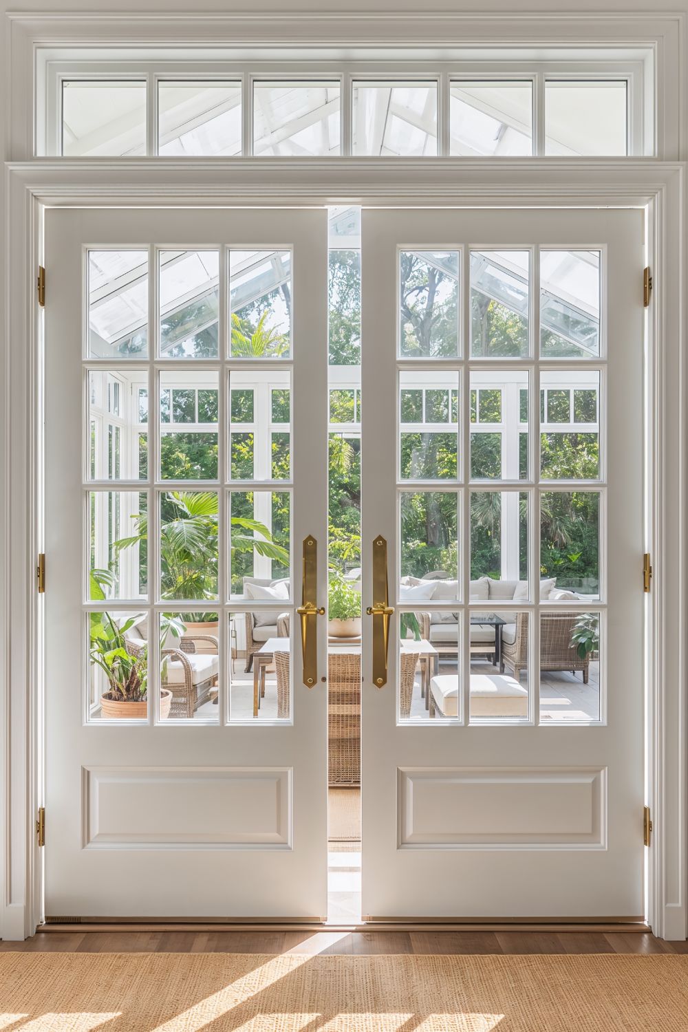 Classic White French Doors Opening To Bright Sunroom