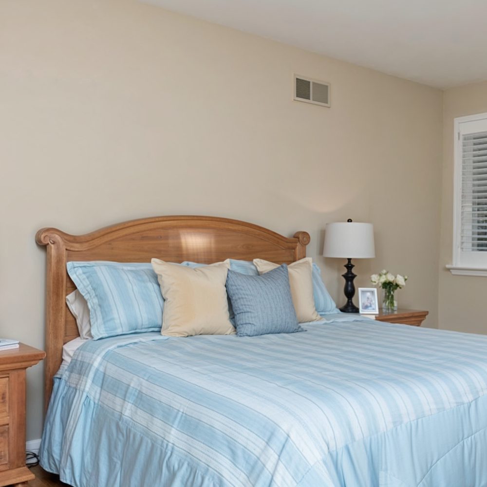 06 cozy master bedroom with wooden accents in kelce family home
