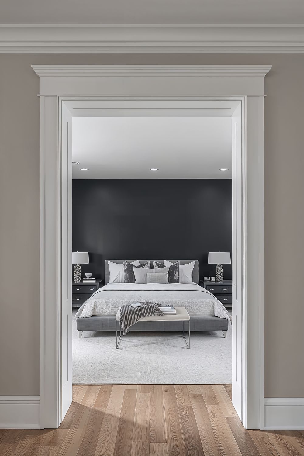Dramatic Matte Black Accent Wall Behind Bed With White Trim