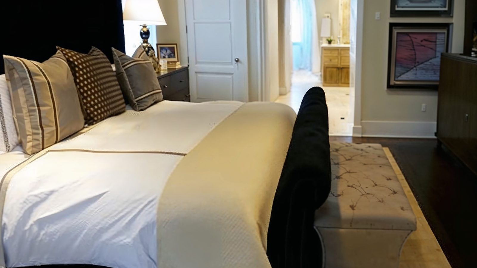 elegant master bedroom with archway and neutral tones