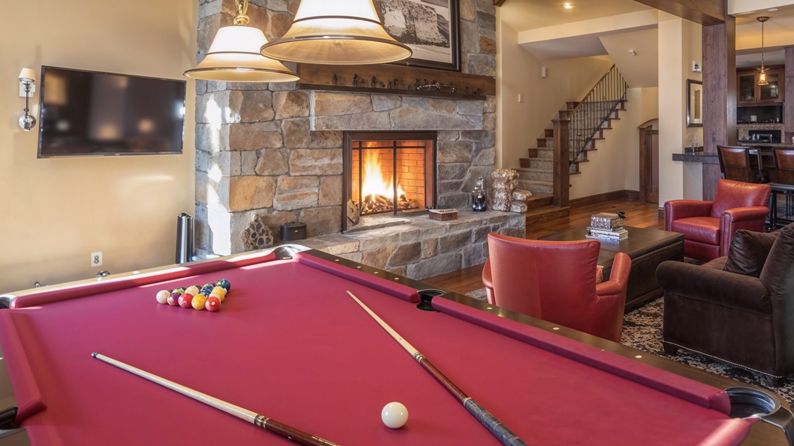 entertainment room with fireplace and pool table