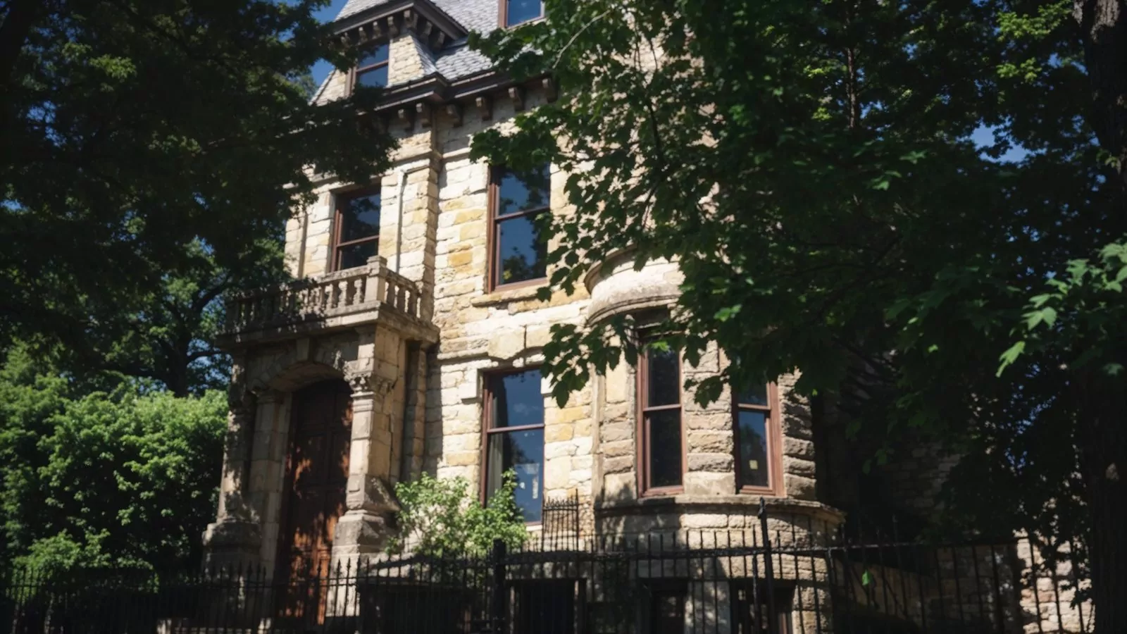 franklin castle in summer with lush greenery and stone facade