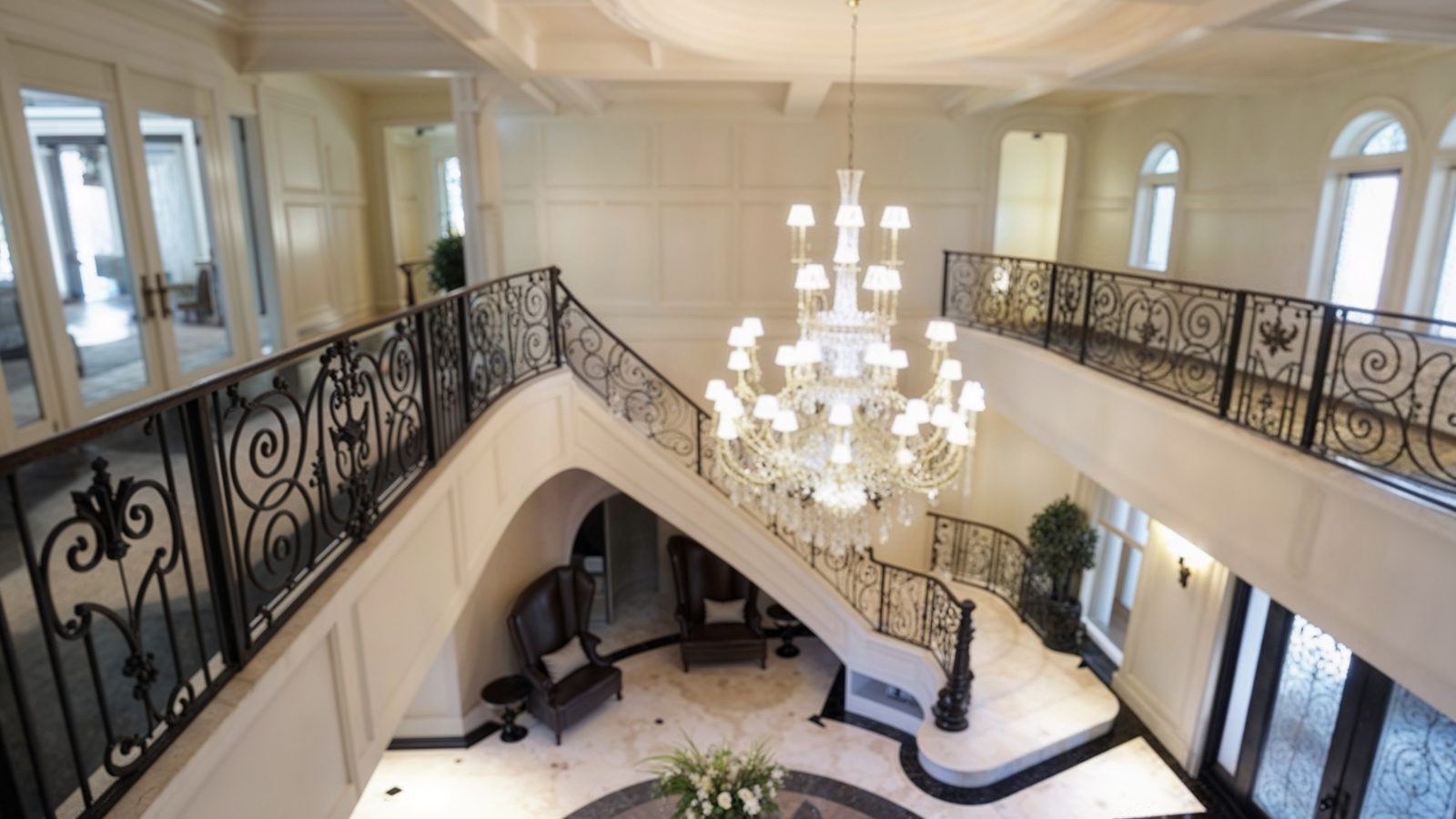 grand foyer with chandelier and winding staircase