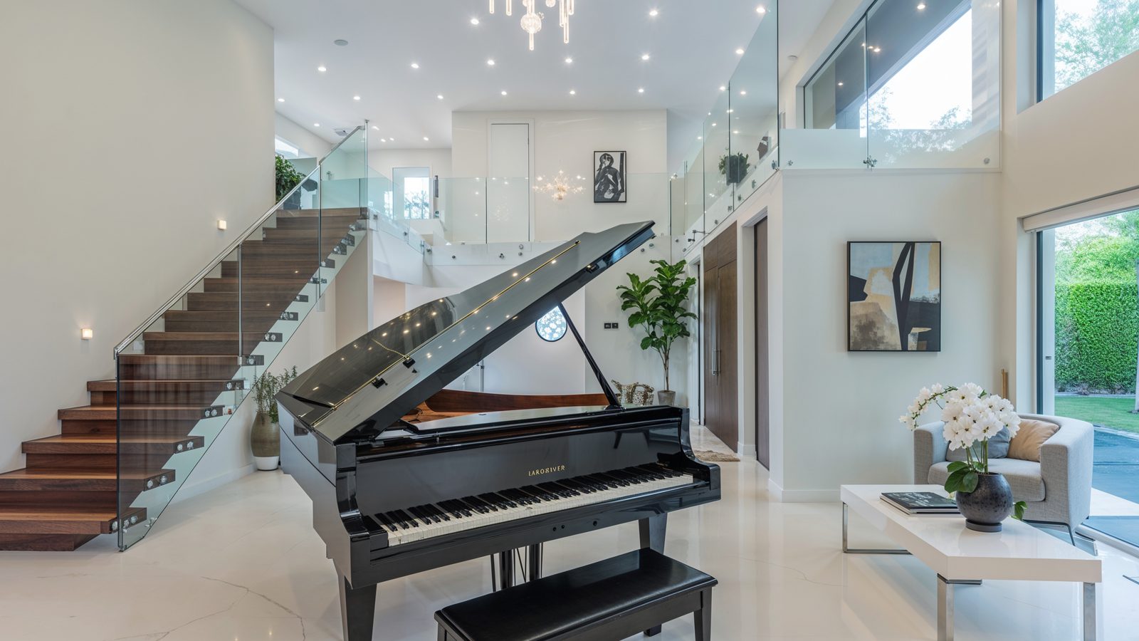 05 grand piano and floating staircase in luxurious entryway