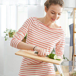 A woman chopping vegetables.