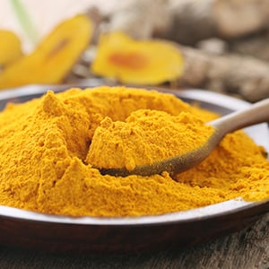 A bowl of organic turmeric. Turmeric provides an abundance of antioxidants capable of supporting cellular health.