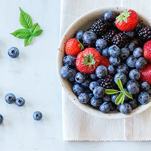 A bowl of fruits. Having a healthy diet can lower your blood sugar.