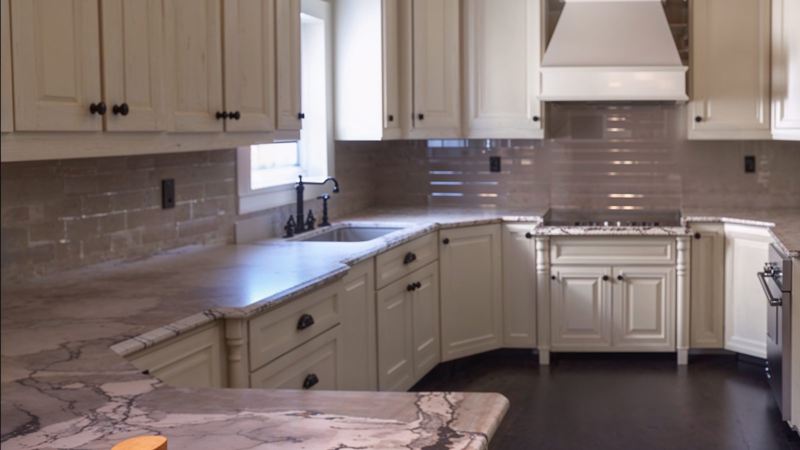 modern kitchen with granite countertops and white cabinets