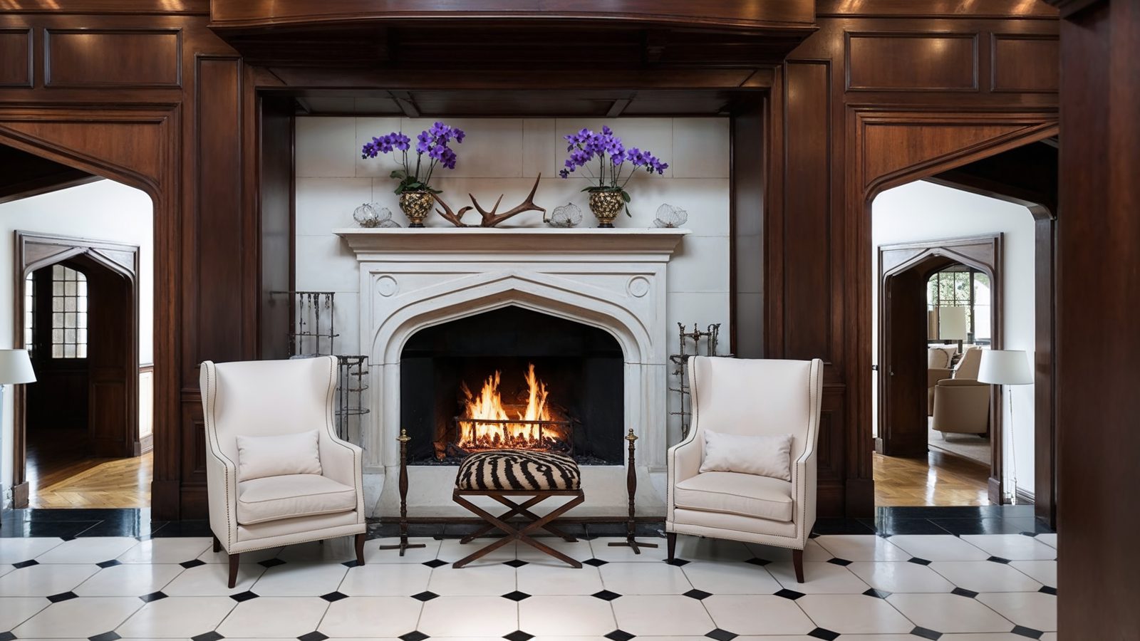 opulent entry hall with grand fireplace and dark wood accents
