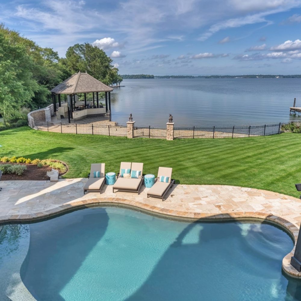 08 poolside with relaxing loungers and stunning lakefront views