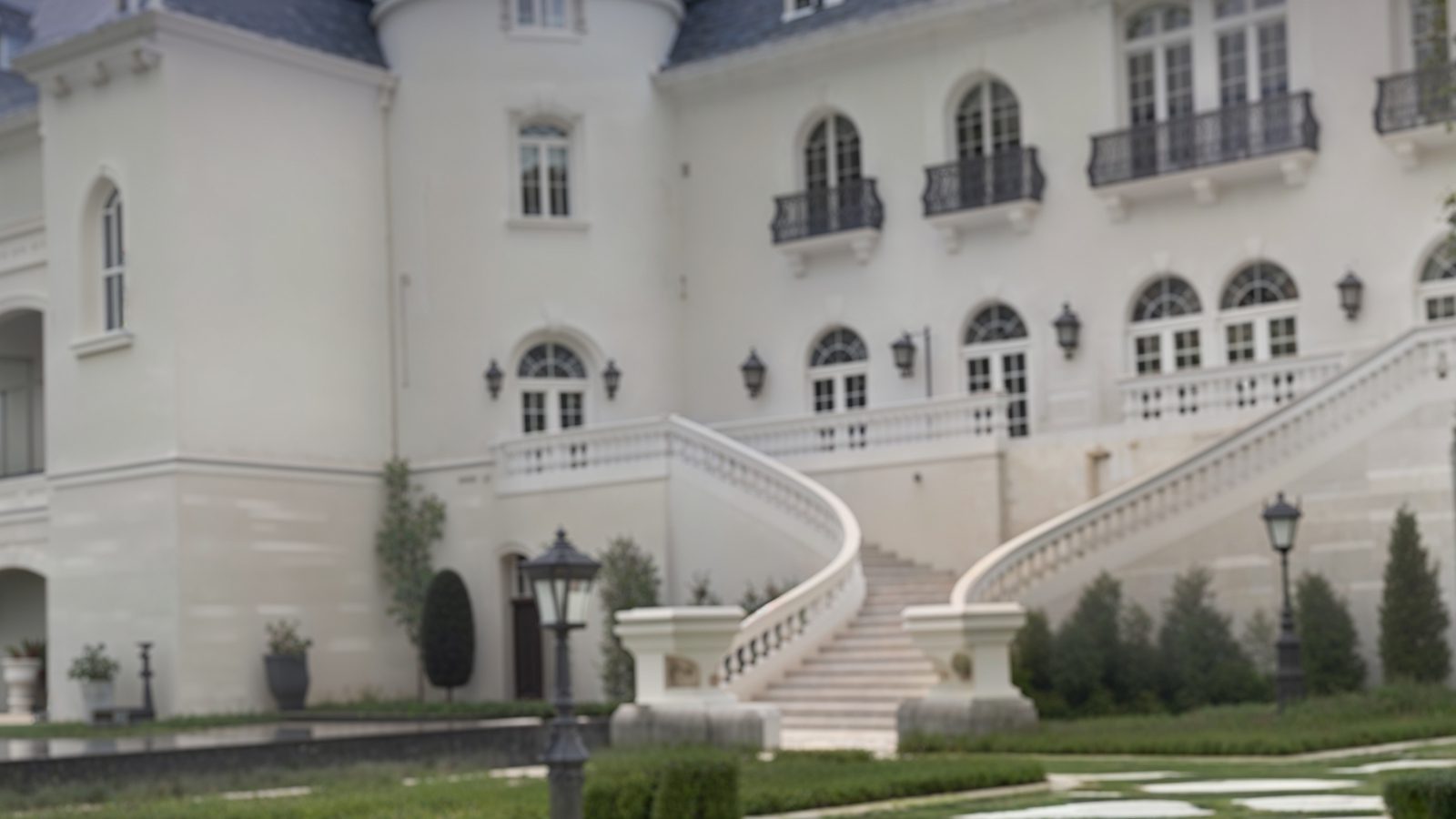 rear mansion facade with grand windows and staircase