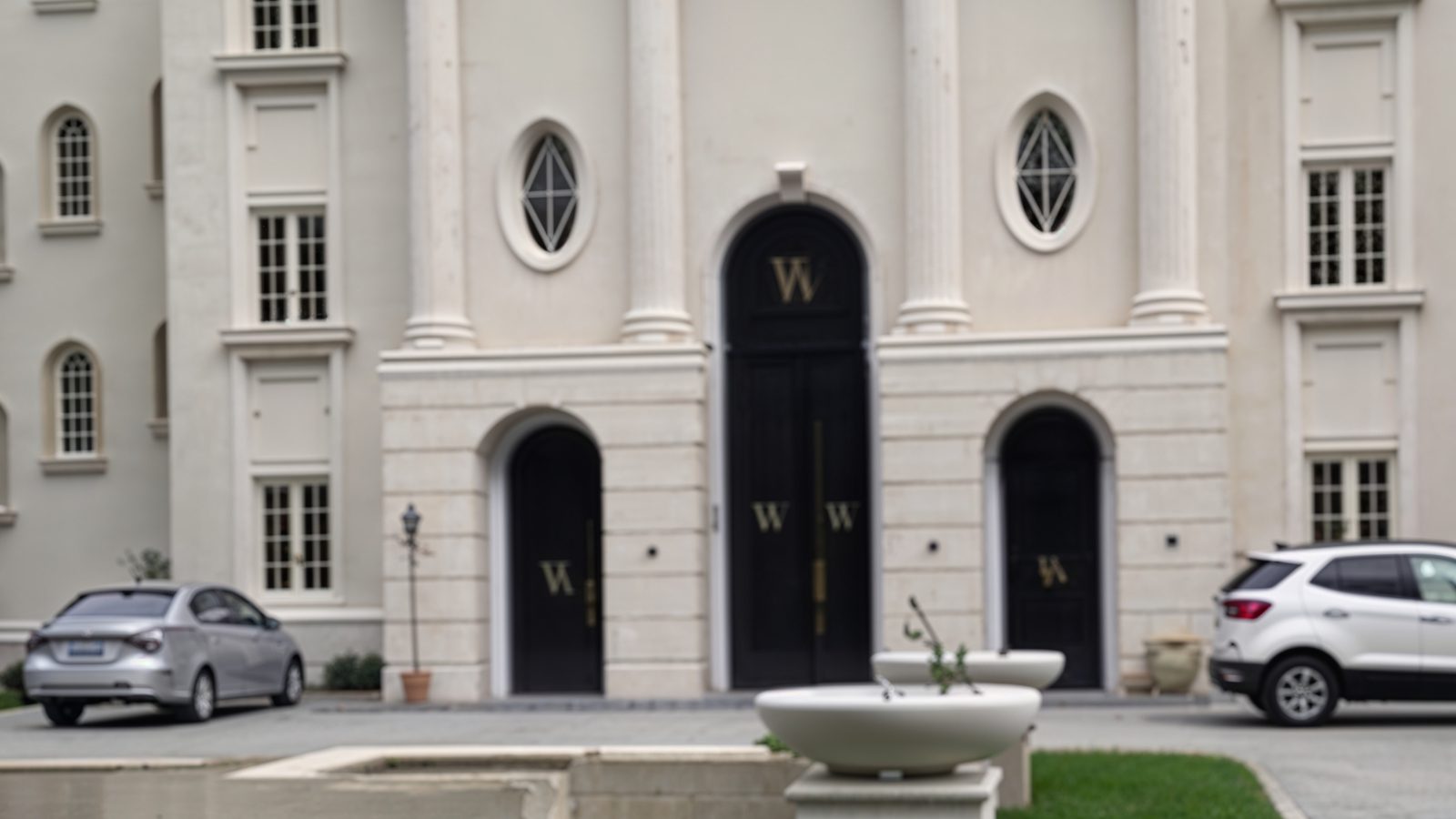 towering entry with double doors and corinthian columns